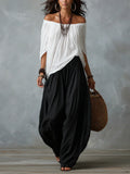 Top Blanco con los Hombros Descubiertos y Pantalones Acampanados Estilo Farol.