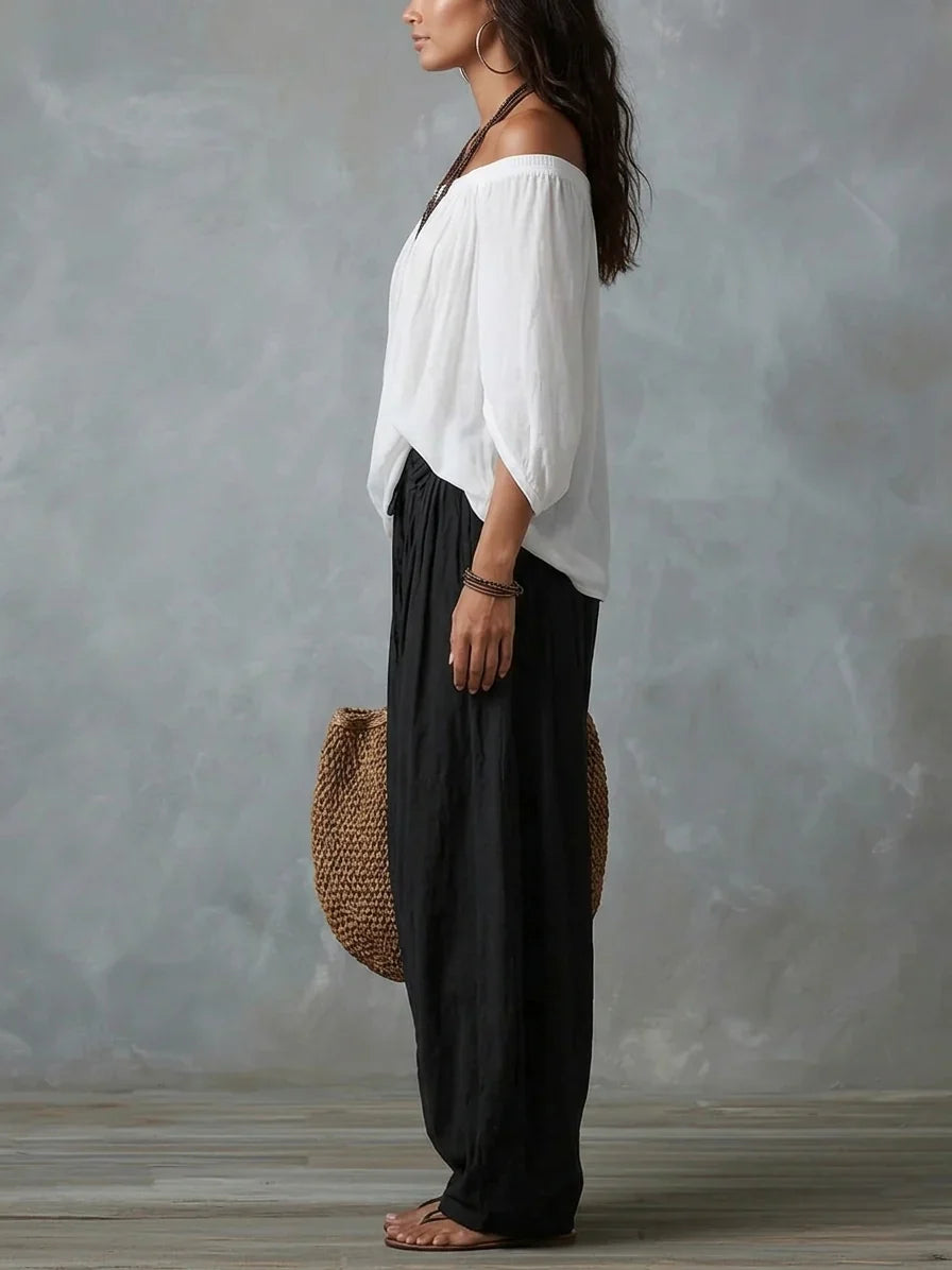 Top Blanco con los Hombros Descubiertos y Pantalones Acampanados Estilo Farol.